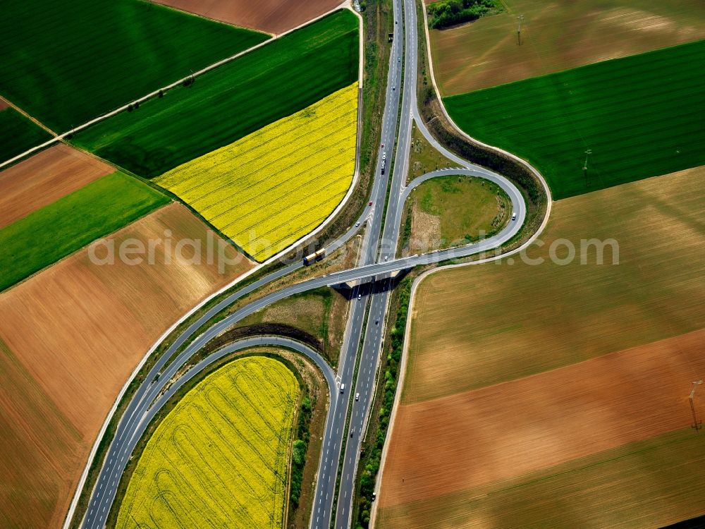 Aerial image Estenfeld - Approach and interchange of the federal highway B19 in Estenfeld in the state of Bavaria. The interchange with its approach is located in the North of Estenfeld. the federal highway is diverted around the village and is located between agricultural fields