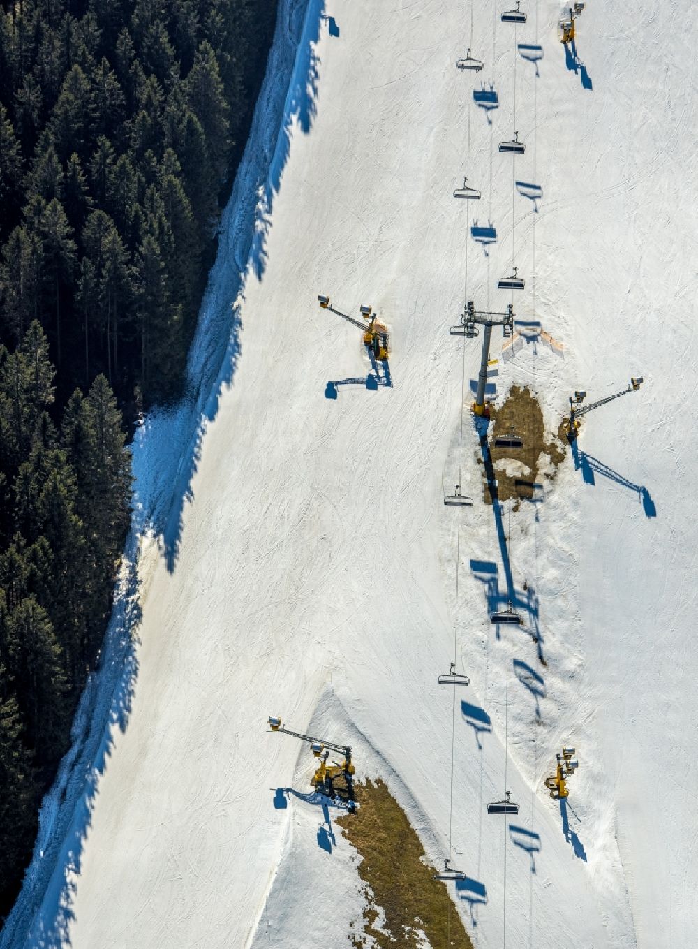 Aerial image Winterberg - Mountain slope with downhill ski slope and cable car - lift in Winterberg on Sauerland in the state North Rhine-Westphalia, Germany