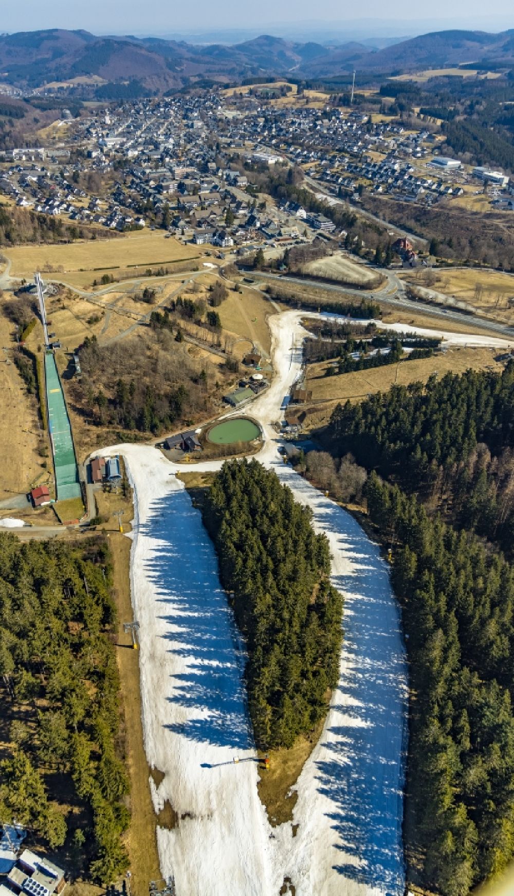 Aerial image Winterberg - Mountain slope with downhill ski slope and cable car - lift in Winterberg on Sauerland in the state North Rhine-Westphalia, Germany