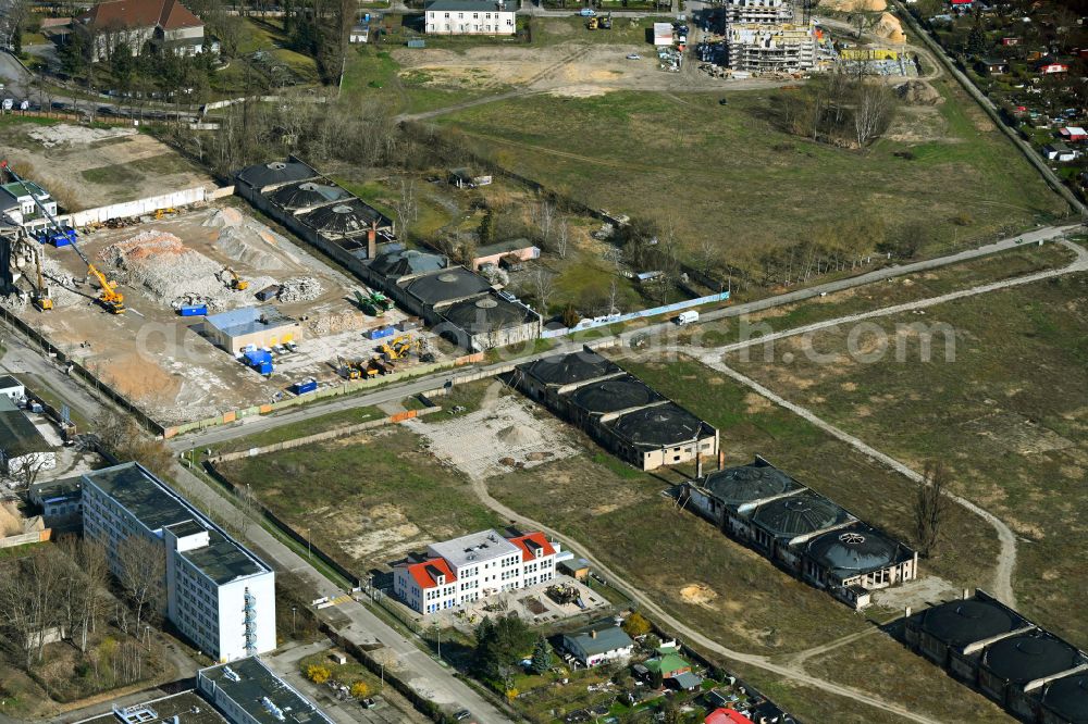 Aerial photograph Berlin - Demolition and clearing work on the building complex of the former military barracks for property development for the new building project of the garden city on Koepenicker Allee - Am Alten Flugplatz in the district Karlshorst in Berlin, Germany