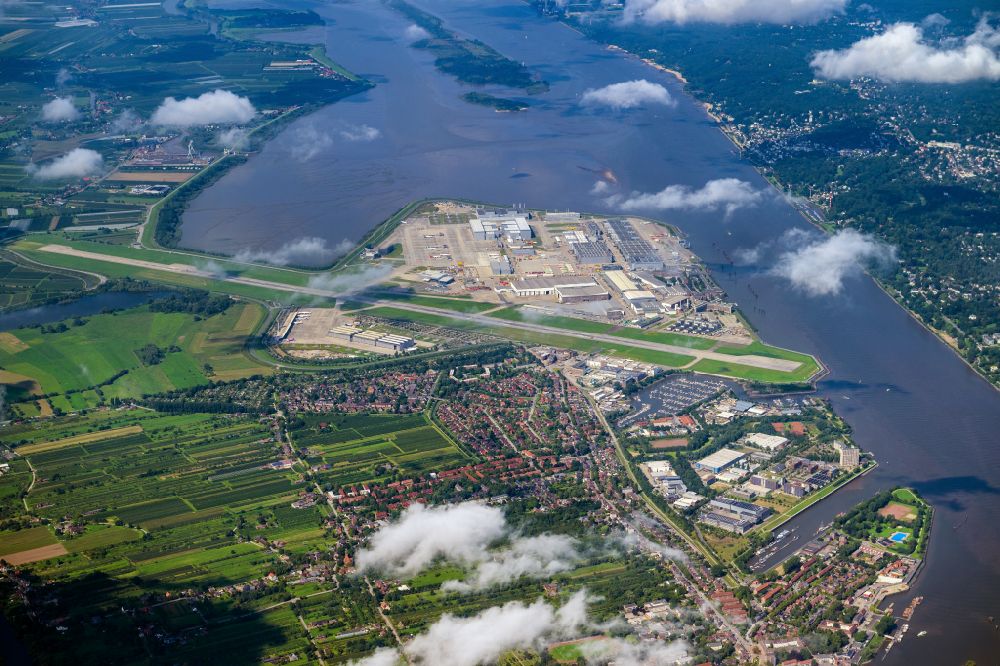 Hamburg from the bird's eye view: Airbus works and airport of Finkenwerder in Hamburg in Germany. The former Hamburger Flugzeugbau works - on the Finkenwerder Peninsula on the riverbank of the Elbe - include an Airbus production site with an airplane. Several Airbus planes and models are being constructed here