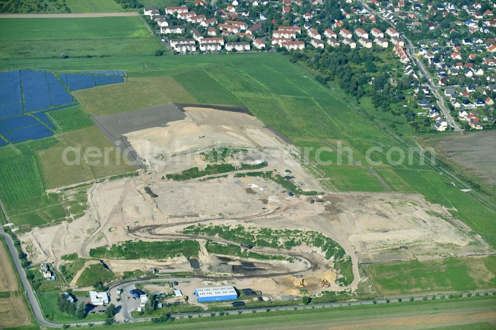 Großziethen from the bird's eye view: Abandoned waste disposal site Deponie Grossziehten in Schoenefeld in the state of Brandenburg. The brownfield in the East of Grossziethen is surrounded by fields and meadows and is being completely renovated and sanified by Hafemeister Erd- und Tiefbau GmbH