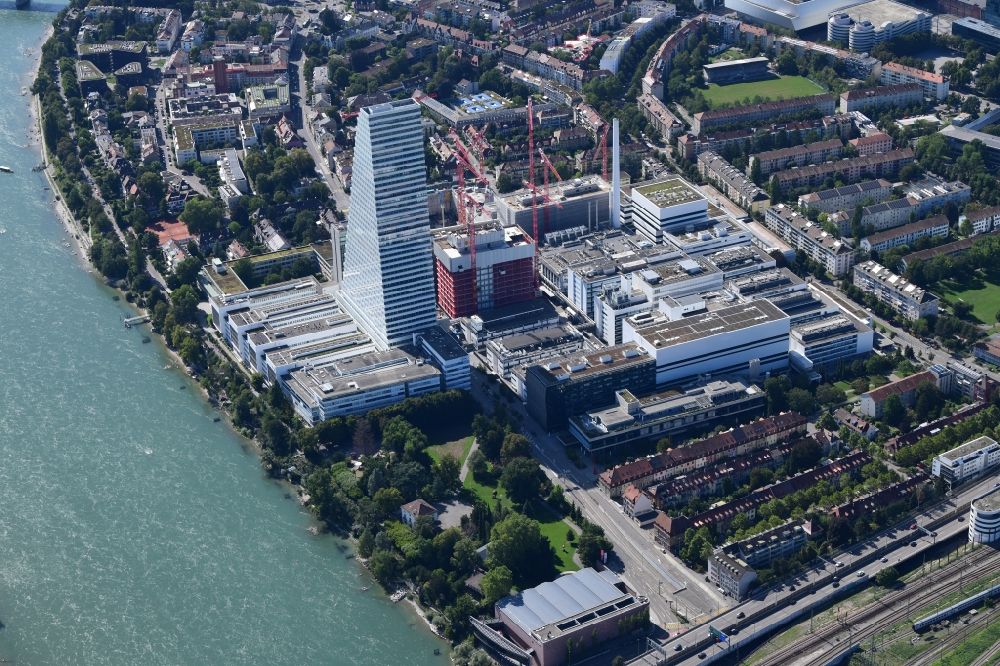 Basel from above - Factory premises of the pharmaceutical company Roche with the landmark building and skyscraper in Basle in Switzerland. Construction works for the second high-rise tower are under way
