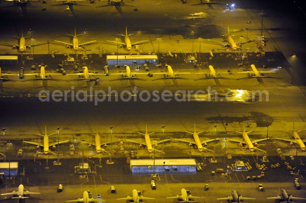 Aerial image at night Schkeuditz - Night lighting check-in buildings and cargo terminals on the grounds of the airport on DHL Hub in Schkeuditz in the state Saxony, Germany