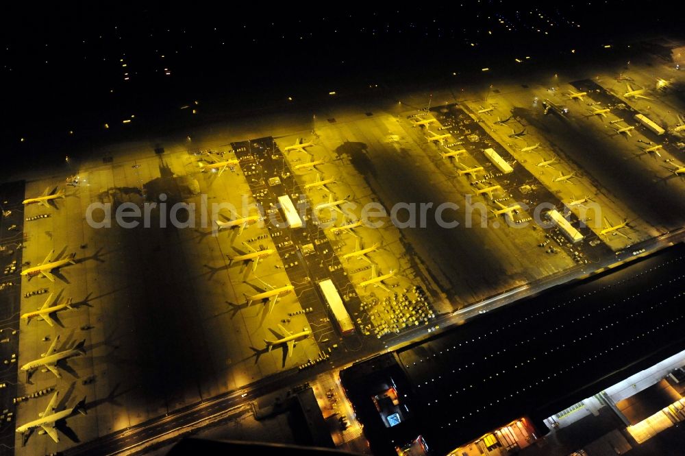 Schkeuditz at night from above - Night lighting check-in buildings and cargo terminals on the grounds of the airport on DHL Hub in Schkeuditz in the state Saxony, Germany