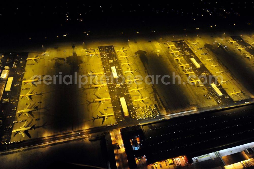 Schkeuditz at night from the bird perspective: Night lighting check-in buildings and cargo terminals on the grounds of the airport on DHL Hub in Schkeuditz in the state Saxony, Germany