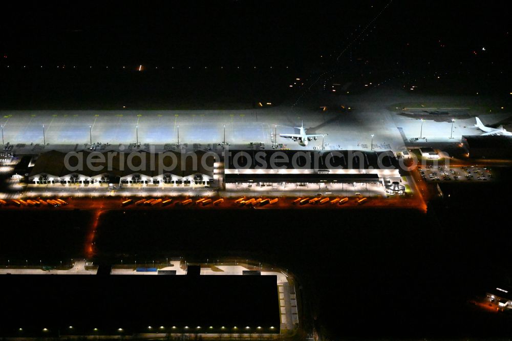 Schkeuditz at night from above - Night lighting check-in buildings and cargo terminals on the grounds of the airport World-Cargo-Center Leipzig on street Hans-Wittwer-Strasse in the district Doelzig in Schkeuditz in the state Saxony, Germany