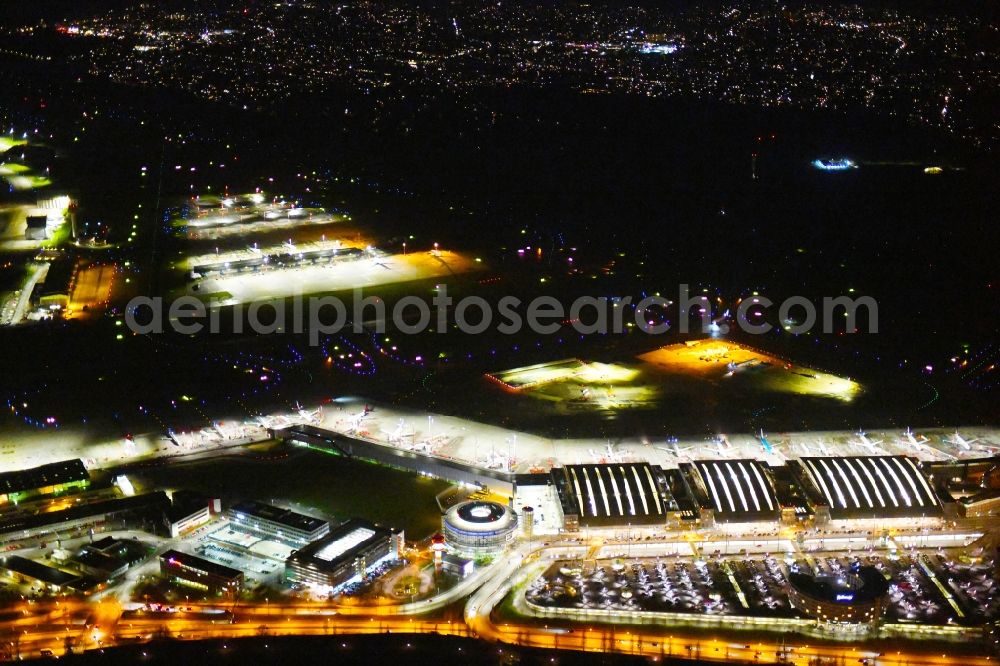 Aerial image at night Hamburg - Night lighting dispatch building and terminals on the premises of the airport Hamburg Airport Helmut Schmidt (ICAO-Code:EDDH) in the district Fuhlsbuettel in Hamburg, Germany