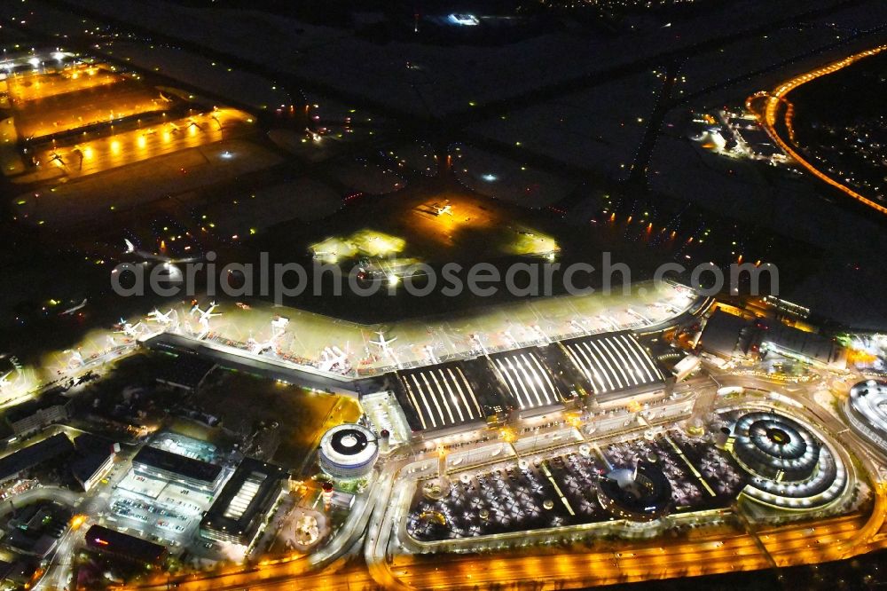 Hamburg at night from above - Night lighting dispatch building and terminals on the premises of the airport Hamburg Airport Helmut Schmidt (ICAO-Codea??: a??EDDH) in the district Fuhlsbuettel in Hamburg, Germany