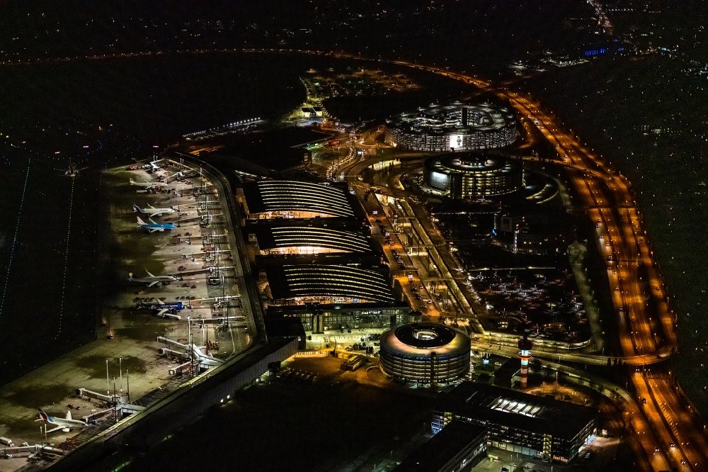 Hamburg at night from above - Night lighting dispatch building and terminals on the premises of the airport Hamburg Airport Helmut Schmidt (ICAO-Code EDDH) in the district Fuhlsbuettel in Hamburg, Germany