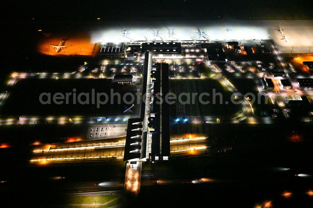 Aerial image at night Schkeuditz - Night lighting dispatch building and terminals on the premises of the airport of Flughafen Leipzig/Halle GmbH in Schkeuditz in the state Saxony, Germany
