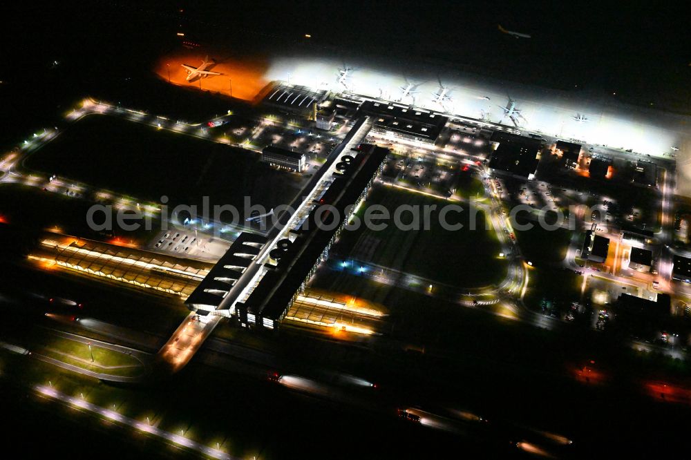 Schkeuditz at night from above - Night lighting dispatch building and terminals on the premises of the airport of Flughafen Leipzig/Halle GmbH in Schkeuditz in the state Saxony, Germany