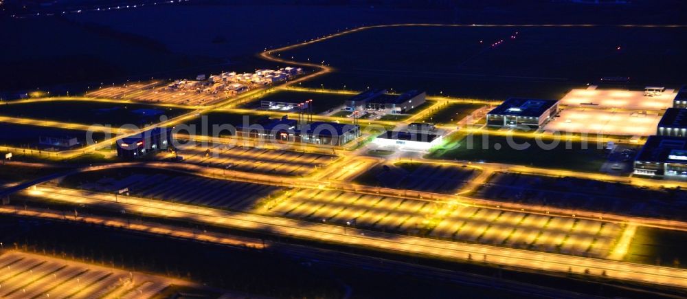 Schönefeld at night from above - Night lighting dispatch building and terminals on the premises of the airport BER in Schoenefeld in the state Brandenburg
