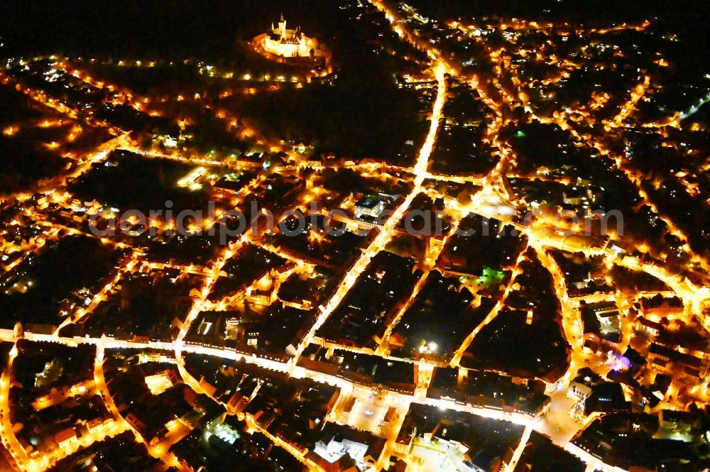 Wernigerode at night from the bird perspective: Night lighting old Town area and city center in Wernigerode in the state Saxony-Anhalt, Germany