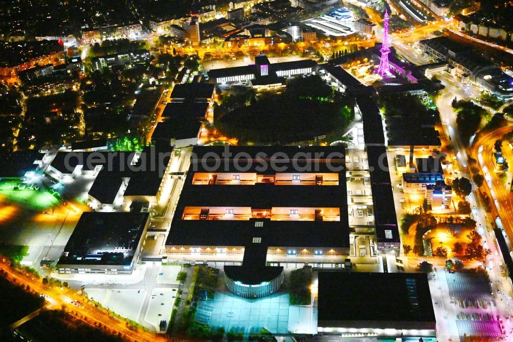 Aerial image at night Berlin - Night lighting exhibition grounds and exhibition halls on Messedamm - Kongresszentrum ICC in the district Charlottenburg in Berlin, Germany