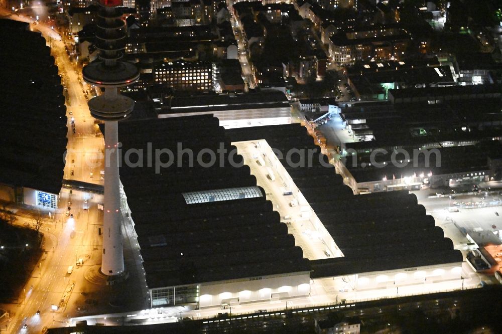 Hamburg at night from the bird perspective: Night lighting exhibition grounds and exhibition halls of the Neue Messe at the broadcasting tower Heinrich-Hertz-Turm in Hamburg, Germany