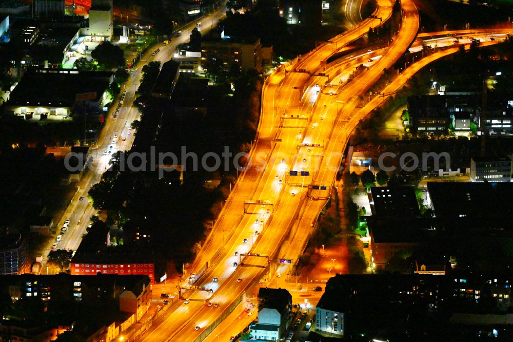Aerial photograph at night Berlin - Night view routing and traffic lanes during the highway exit and access the motorway A 100 - 113 Grenzallee destrict Neukoelln in Berlin
