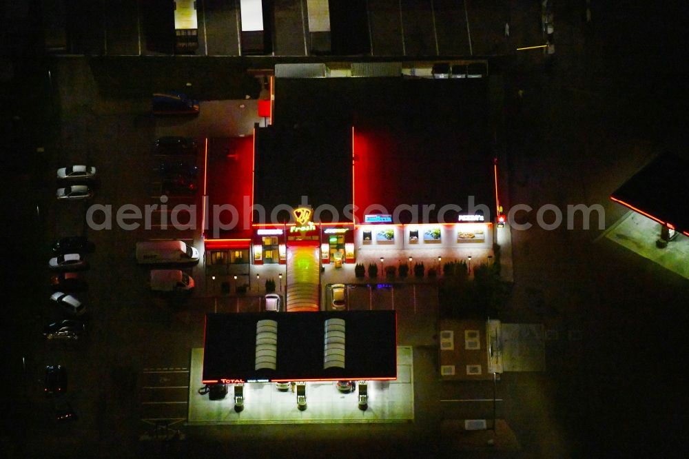 Aerial photograph at night Landsberg - Night lighting Routing and traffic lanes during the motorway service station and parking lot of the BAB A 14 TOTAL Autohof in Landsberg in the state Saxony-Anhalt, Germany