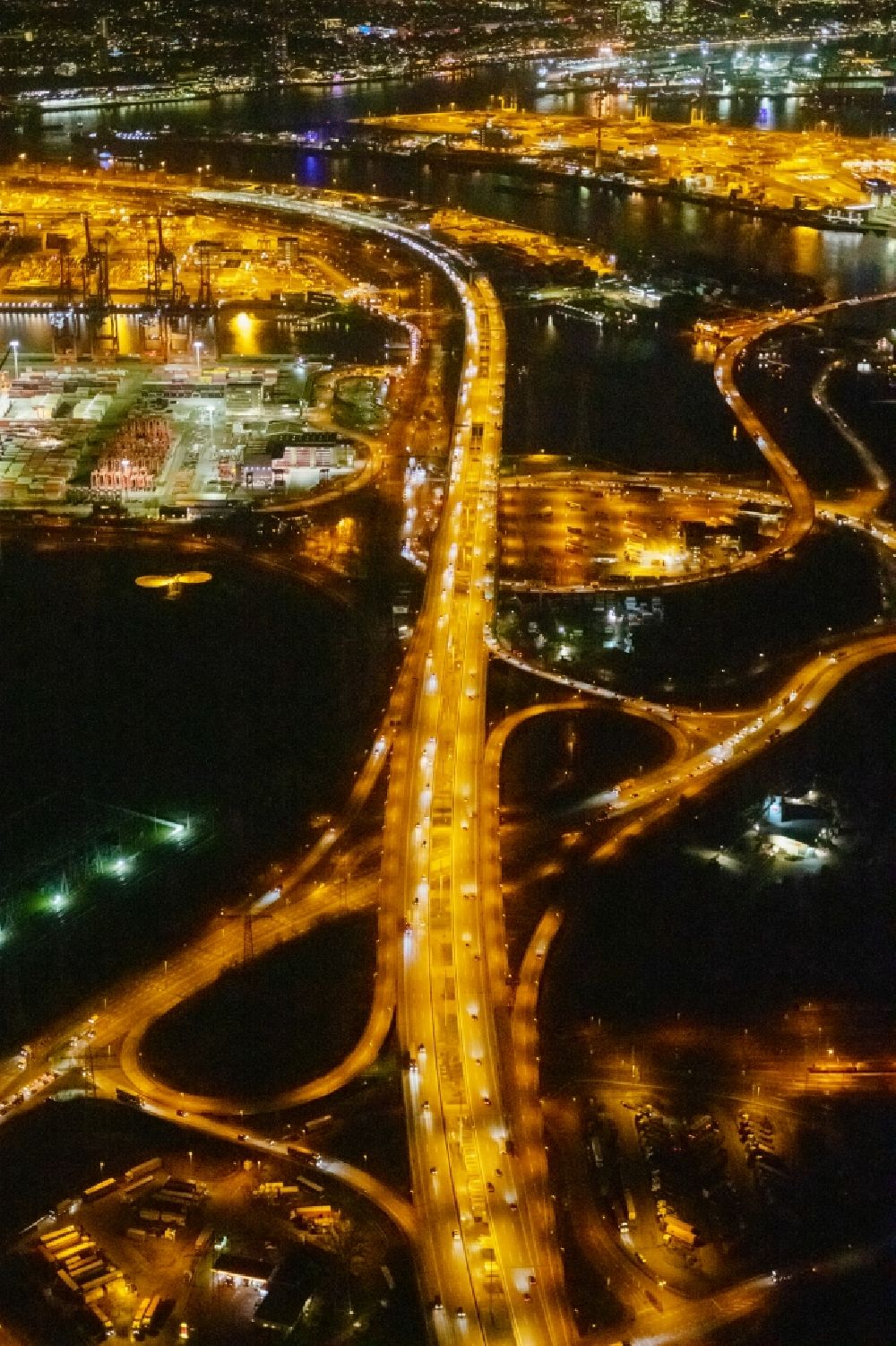 Aerial photograph at night Hamburg - Night lighting lanes of the motorway- route and course of the A7 in the district Altenwerder in Hamburg, Germany