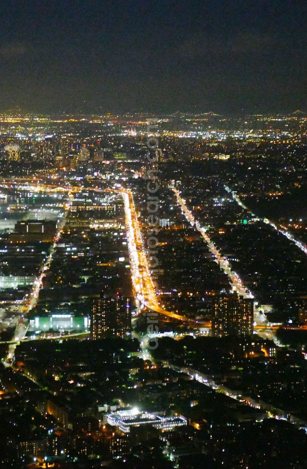 New York at night from the bird perspective: Night lighting Lanes of the motorway- route and course of the Belt Pkwy 278 in the district Brooklyn in New York in United States of America