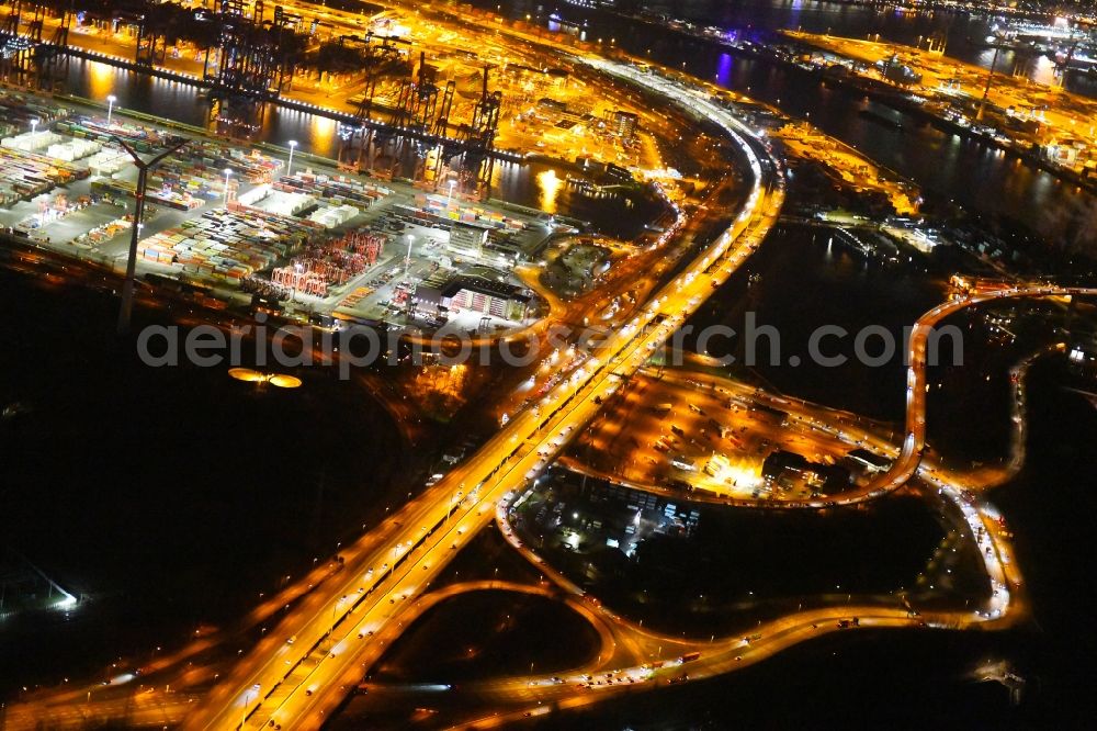 Hamburg at night from above - Night lighting routing and traffic lanes during the highway exit and access the motorway A 7 in the district Altenwerder in Hamburg, Germany