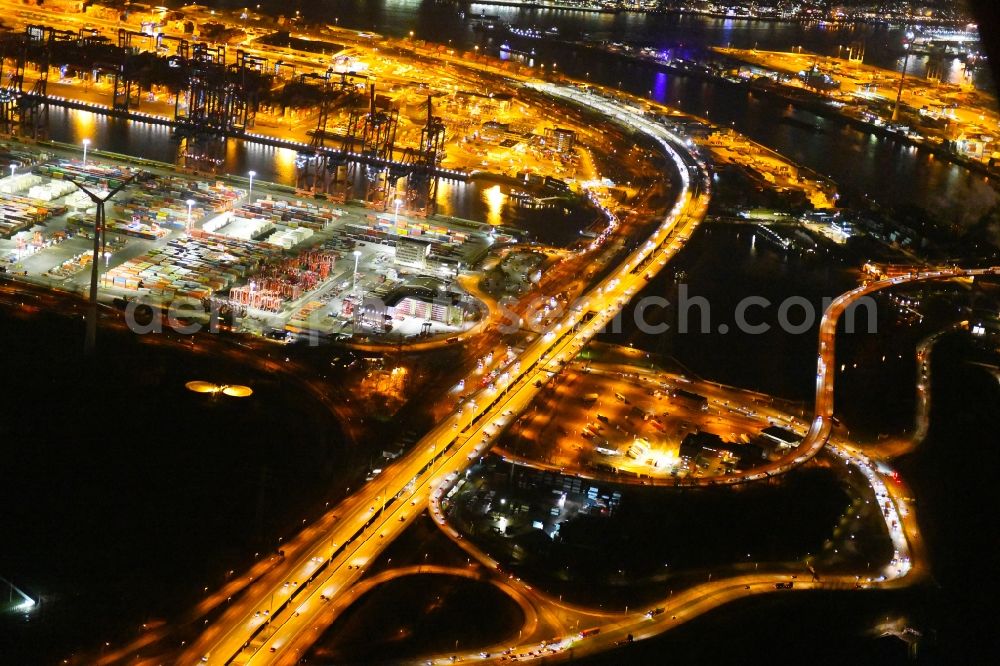Hamburg at night from the bird perspective: Night lighting routing and traffic lanes during the highway exit and access the motorway A 7 in the district Altenwerder in Hamburg, Germany