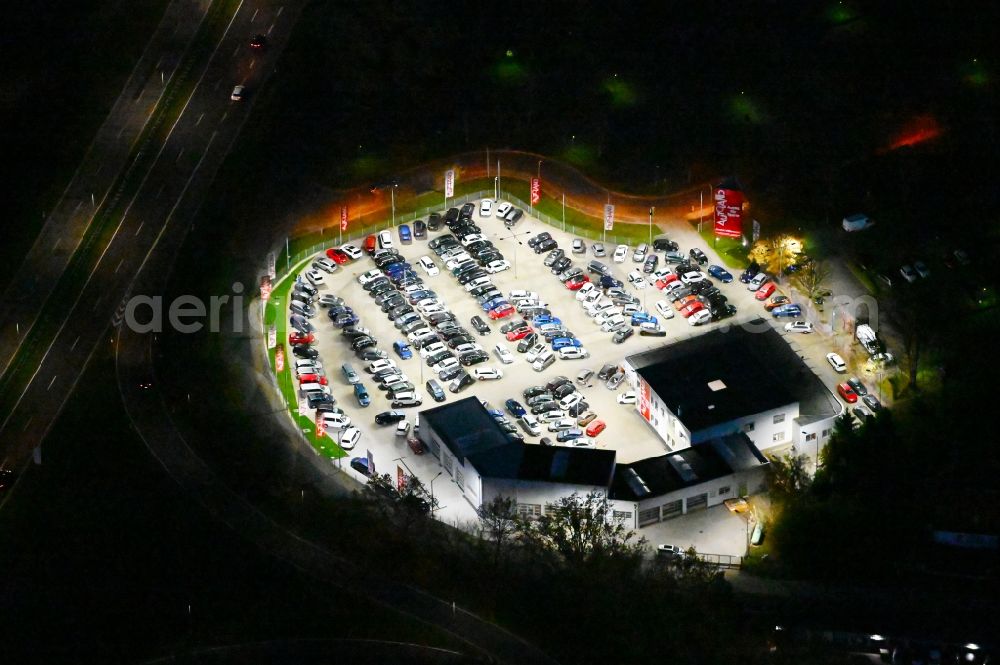 Magdeburg at night from the bird perspective: Night lighting car dealership building of Autoland AG in the district Reform in Magdeburg in the state Saxony-Anhalt, Germany