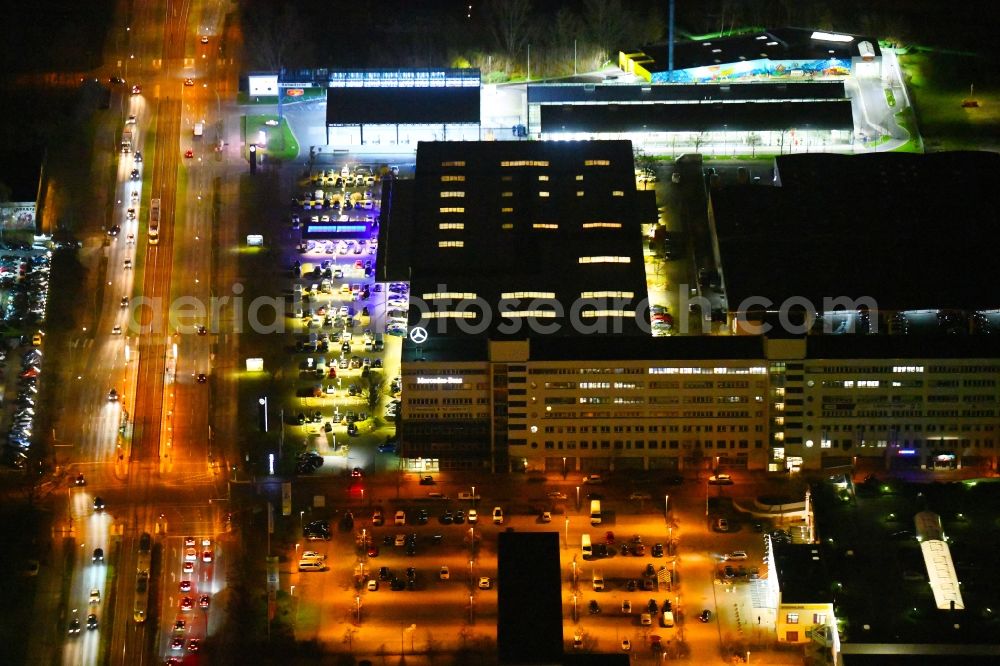 Aerial photograph at night Berlin - Night lighting car dealership building of Daimler AG on Rhinstrasse in the district Marzahn in Berlin, Germany
