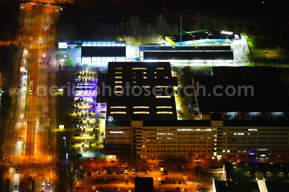 Aerial image at night Berlin - Night lighting car dealership building of Daimler AG on Rhinstrasse in the district Marzahn in Berlin, Germany