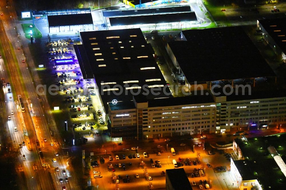 Berlin at night from the bird perspective: Night lighting car dealership building of Daimler AG on Rhinstrasse in the district Marzahn in Berlin, Germany