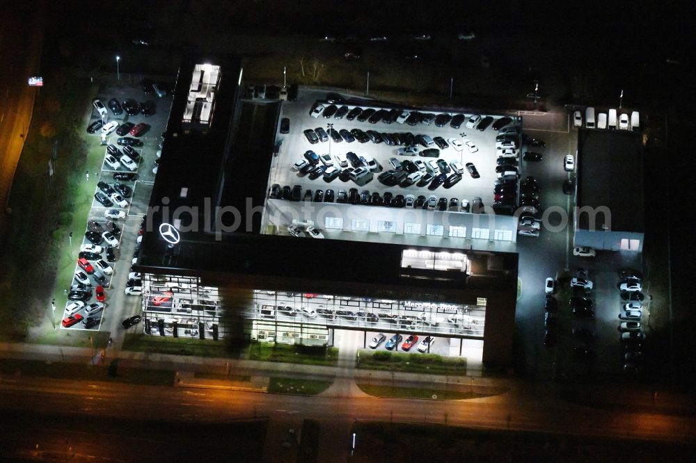 Aerial photograph at night Schönefeld - Night lighting car dealership building Mercedes-Benz Niederlassung Berlin on Hans-Grade-Allee in Schoenefeld in the state Brandenburg, Germany