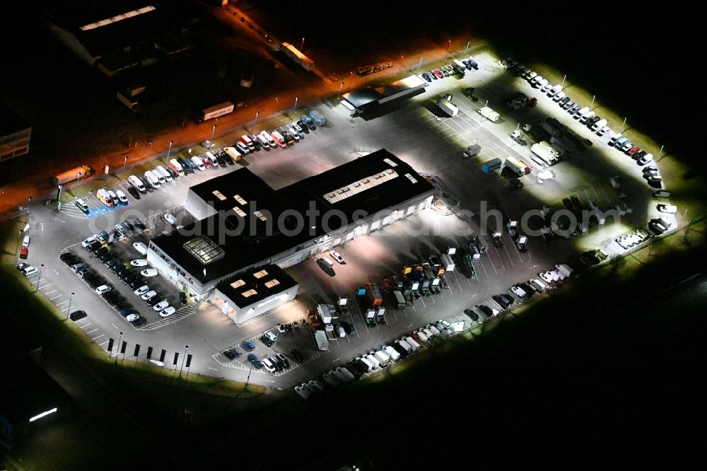 Wesenberg at night from above - Night lighting car dealership building on Stubbendorfer Ring in the district Stubbendorf in Wesenberg in the state Schleswig-Holstein, Germany