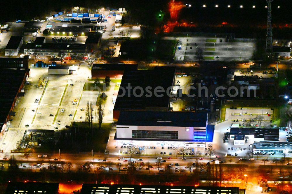 Berlin at night from above - Night lighting car dealership building BMW Autohaus Nefzger on street Nonnendammallee in the district Siemensstadt in Berlin, Germany