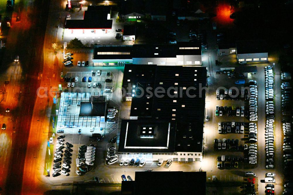 Aerial photograph at night Berlin - Night lighting car dealership building MOeBUS on street Hansastrasse in the district Weissensee in Berlin, Germany