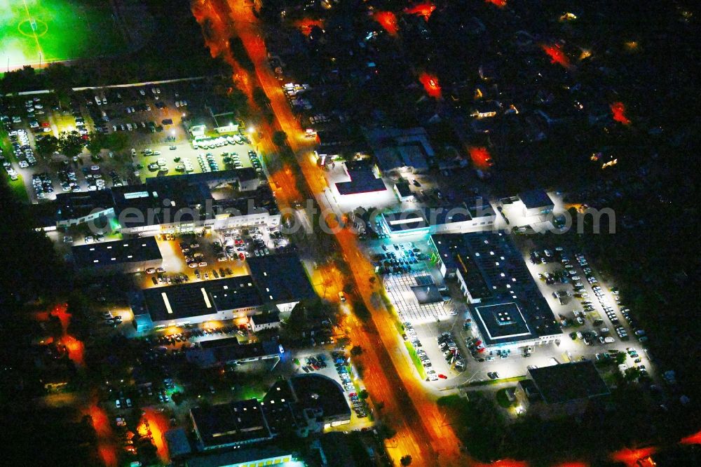 Aerial image at night Berlin - Night lighting car dealership building Volkswagen Group Retail Deutschland on street Hansastrasse in the district Weissensee in Berlin, Germany