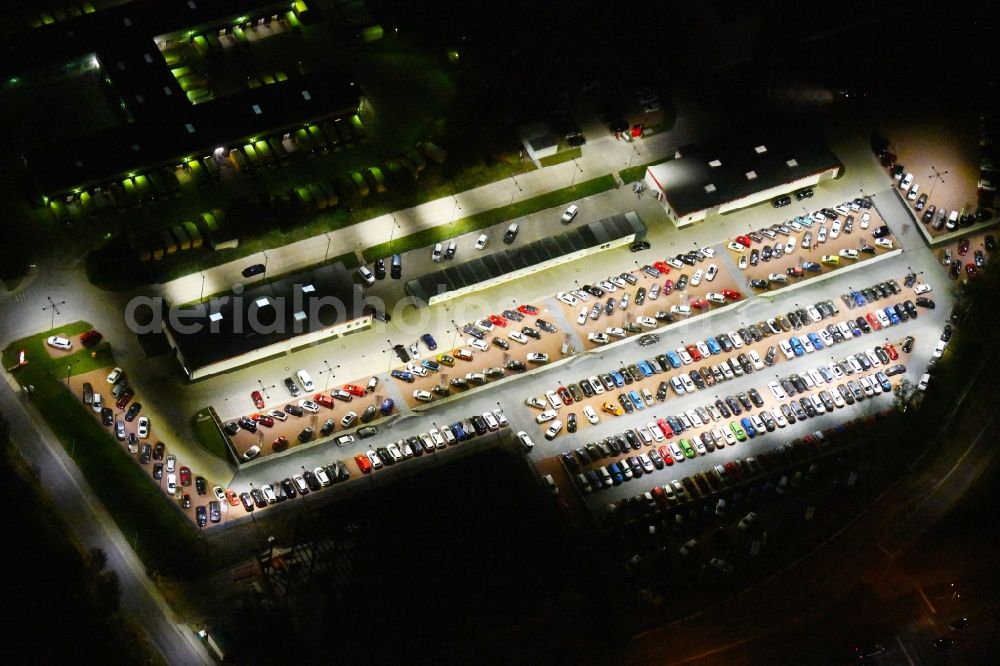 Aerial photograph at night Berlin - Night lighting parking and storage space for automobiles of and buildings of the Autohaus Autoland Niederlassung Berlin Alt-Friedrichsfelde in Berlin, Germany