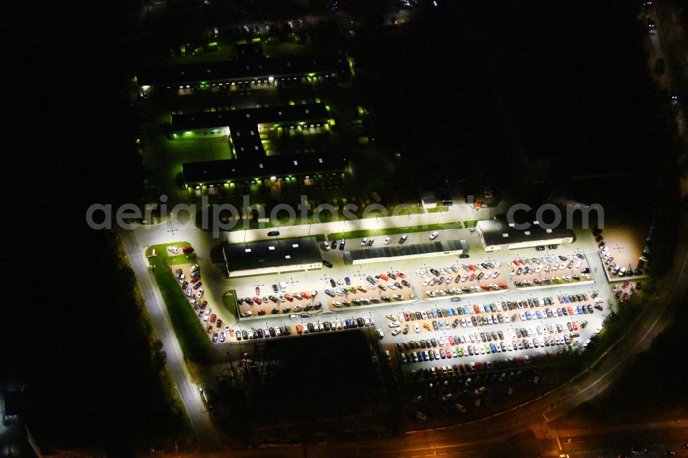 Aerial image at night Berlin - Night lighting parking and storage space for automobiles of and buildings of the Autohaus Autoland Niederlassung Berlin Alt-Friedrichsfelde in Berlin, Germany