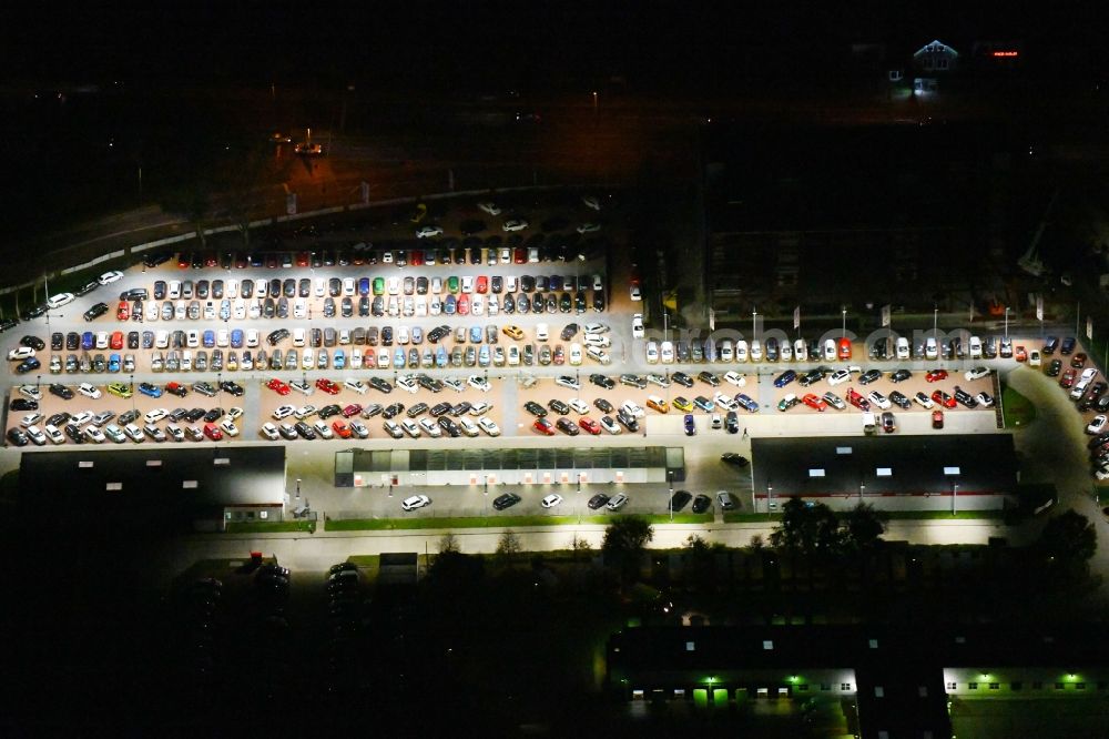 Aerial image at night Berlin - Night lighting parking and storage space for automobiles of and buildings of the Autohaus Autoland Niederlassung Berlin Alt-Friedrichsfelde in Berlin, Germany