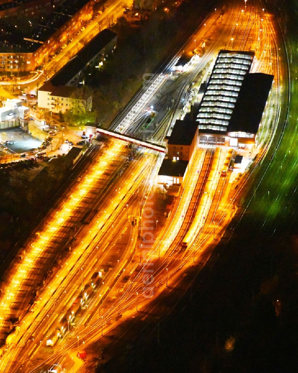 Aerial image at night Berlin - Night lighting Railway depot and repair shop for maintenance and repair of trains of passenger transport of the series of S-Bahn Berlin GmbH in the district Lichtenberg in Berlin, Germany