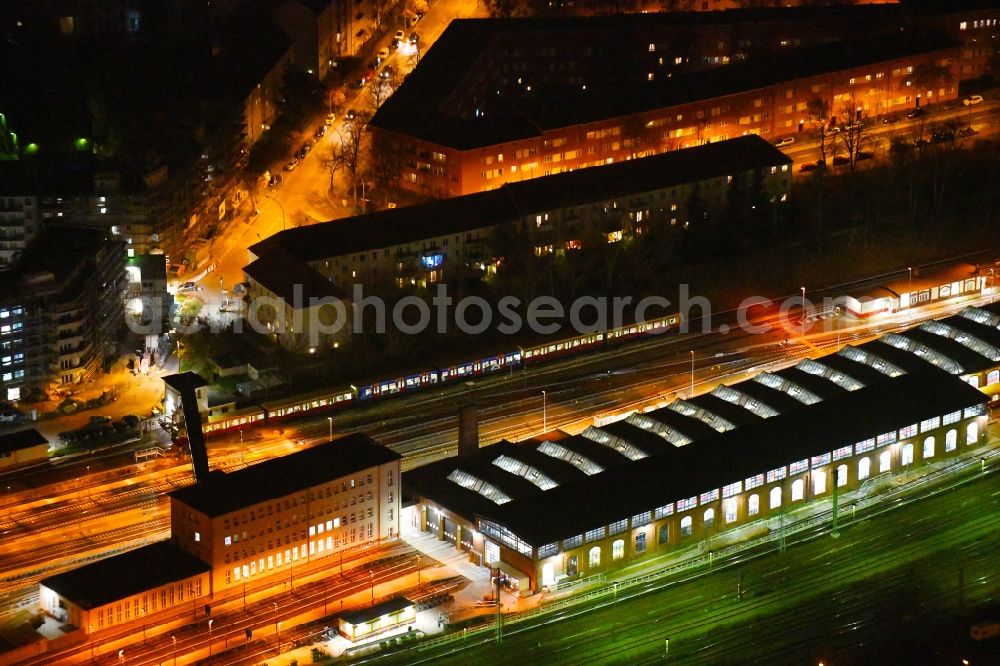 Aerial photograph at night Berlin - Night lighting railway depot and repair shop for maintenance and repair of trains of passenger transport of the series of S-Bahn Berlin GmbH in the district Lichtenberg in Berlin, Germany