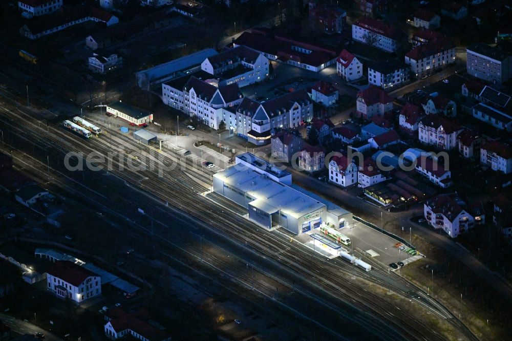 Meiningen at night from the bird perspective: Night lighting railway depot and repair shop for maintenance and repair of trains of passenger transport Sued Thueringen Bahn in Meiningen in the state Thuringia, Germany
