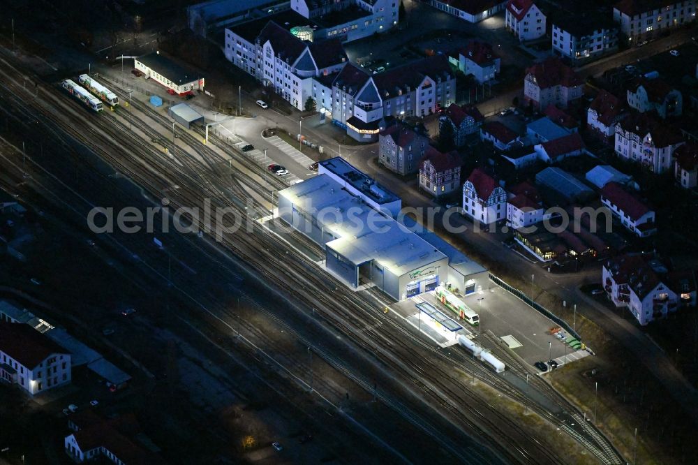 Aerial image at night Meiningen - Night lighting railway depot and repair shop for maintenance and repair of trains of passenger transport Sued Thueringen Bahn in Meiningen in the state Thuringia, Germany