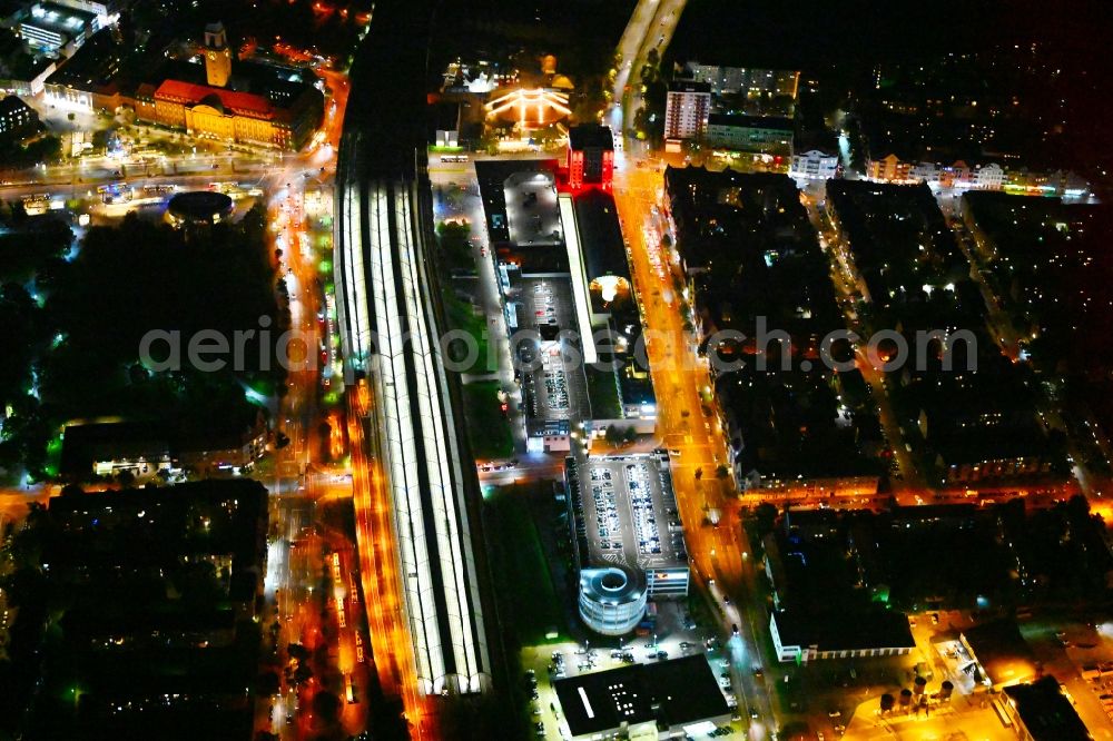 Berlin at night from the bird perspective: Night lighting station building and track systems of the S-Bahn station Spandau and then shopping mall Spandau Arcaden on Klosterstrasse in the district Spandau in Berlin, Germany