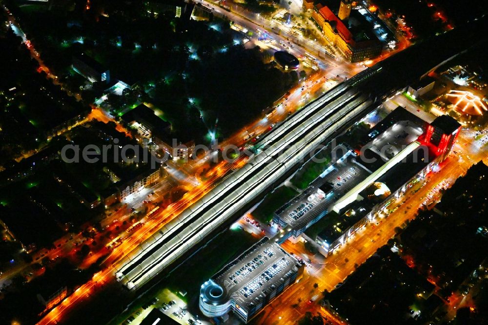 Aerial photograph at night Berlin - Night lighting station building and track systems of the S-Bahn station Spandau and then shopping mall Spandau Arcaden on Klosterstrasse in the district Spandau in Berlin, Germany