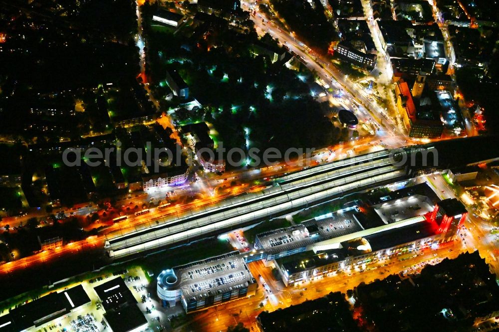 Aerial image at night Berlin - Night lighting station building and track systems of the S-Bahn station Spandau and then shopping mall Spandau Arcaden on Klosterstrasse in the district Spandau in Berlin, Germany