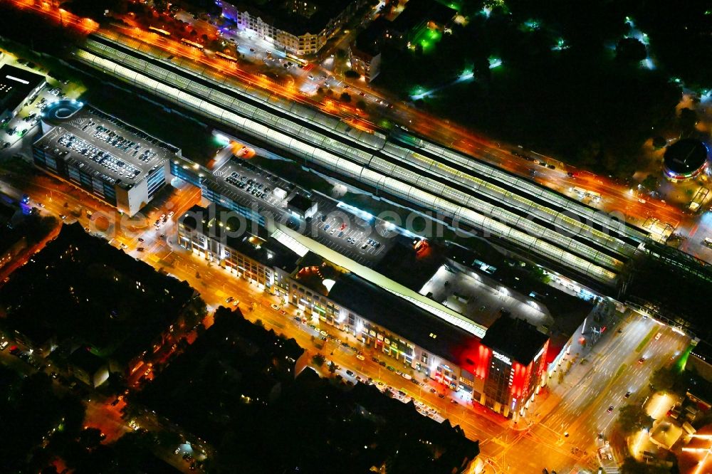 Berlin at night from the bird perspective: Night lighting station building and track systems of the S-Bahn station Spandau and then shopping mall Spandau Arcaden on Klosterstrasse in the district Spandau in Berlin, Germany
