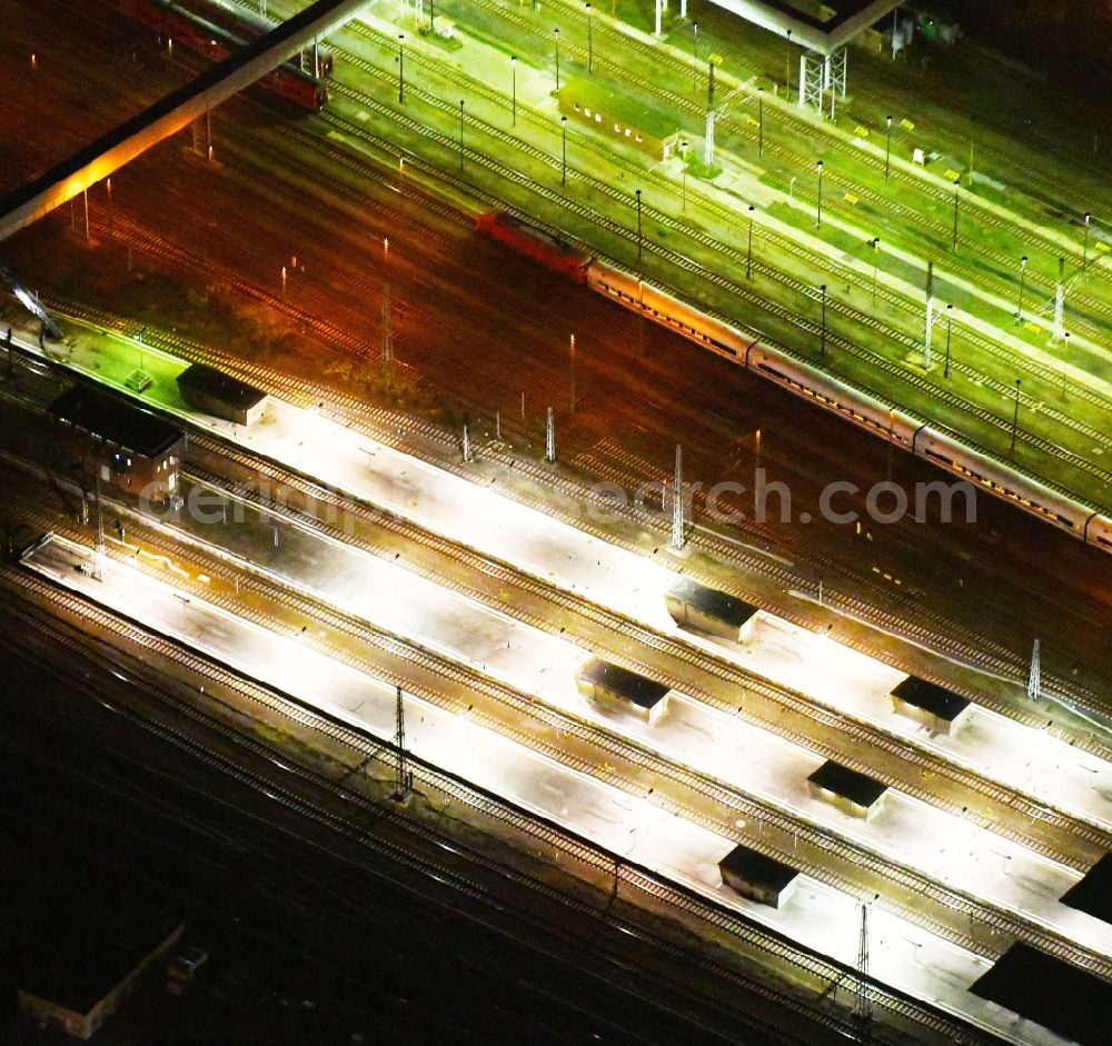Aerial photograph at night Berlin - Night lighting Station building and track systems of the S-Bahn station Berlin - Lichtenberg in the district Lichtenberg in Berlin, Germany