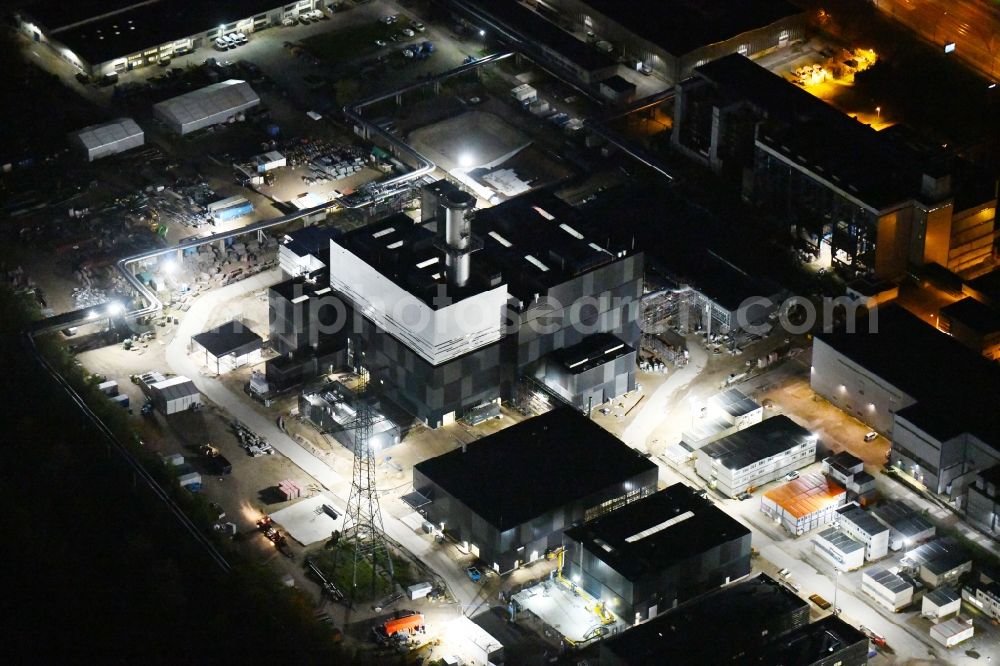 Aerial image at night Berlin - Night lighting construction site of power plants and exhaust towers of thermal power station on Rhinstrasse in the district Marzahn in Berlin, Germany