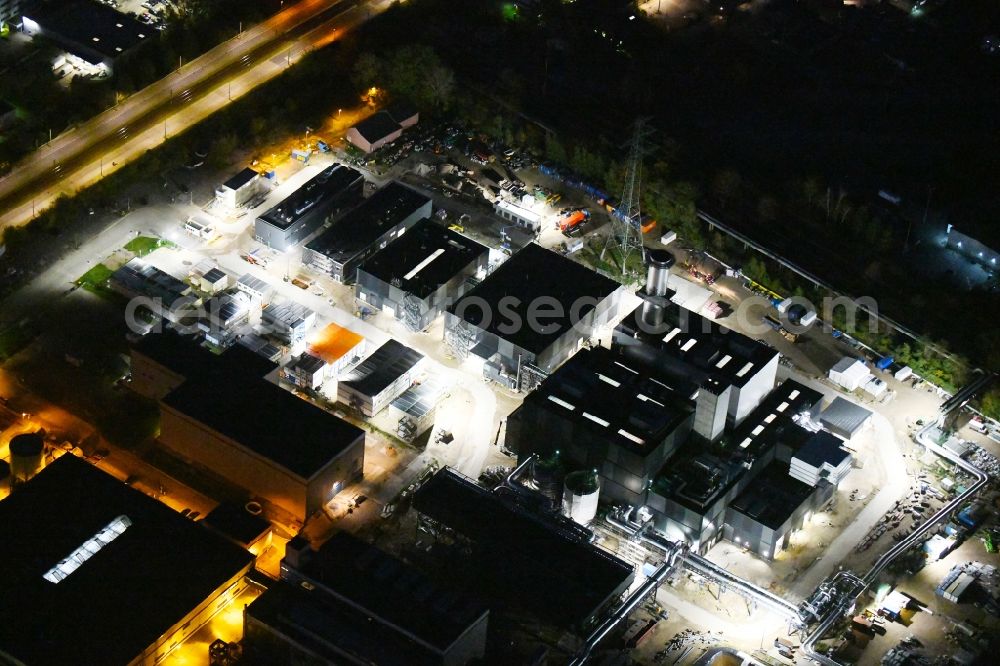 Berlin at night from the bird perspective: Night lighting construction site of power plants and exhaust towers of thermal power station on Rhinstrasse in the district Marzahn in Berlin, Germany