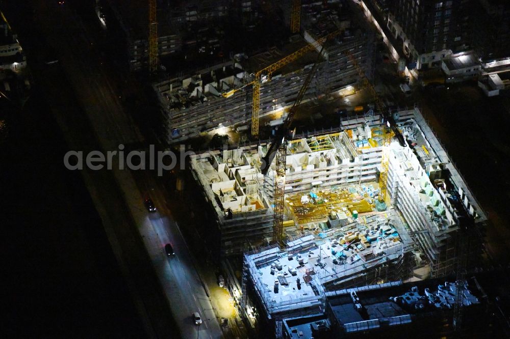 Aerial image at night Hamburg - Night lighting construction site to build a new multi-family residential complex on Baakenallee in the district HafenCity in Hamburg, Germany